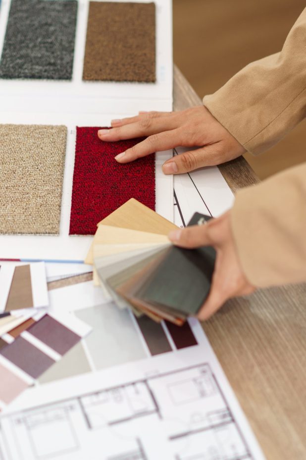 Architectural concept, Female architect choosing color on color Architectural concept, Female architect choosing color on color swatch for house interior design.